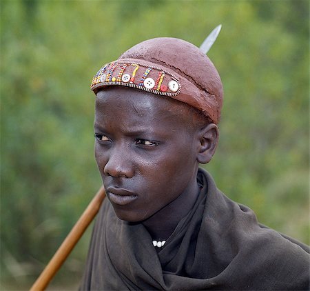 simsearch:862-03366603,k - A Pokot youth has his hair styled with Ochred clay and decorated with beads and buttons to denote his recent circumcision. Foto de stock - Con derechos protegidos, Código: 862-03366277