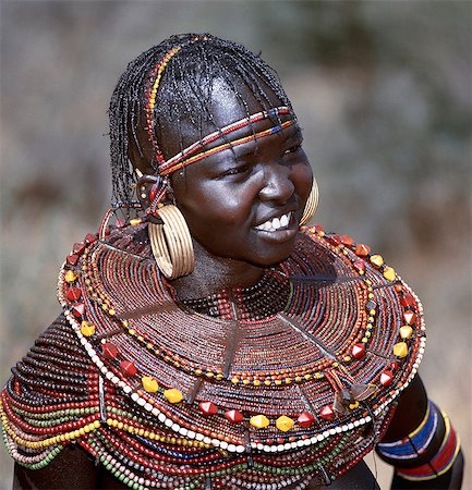 simsearch:400-05021263,k - A young married woman of the Pokot tribe. Her married status is denoted by her large brass earrings and broad beaded collars and necklaces that are smeared with animal fat to glisten in the sun. Foto de stock - Con derechos protegidos, Código: 862-03366282