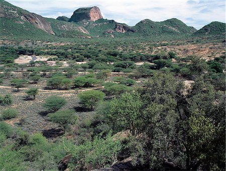 simsearch:862-03808656,k - Poi,a prominent rock feature of the Ndoto Mountains in northern Samburuland. The small river rising at the top of the 8650-foot-high range provides permanent water at Ngurunit for people and their livestock.The Samburu of Northern Kenya are a semi-nomadic pastoral community related to their more famous cousins,the maa speaking Maasai. Stock Photo - Rights-Managed, Code: 862-03366419