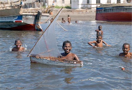 Young boys play with their model boat at Matondoni,Lamu Island. The place has been famous for making traditional wooden sailing boats for a century or more. Stock Photo - Rights-Managed, Code: 862-03366609