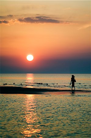 Girl Walking Barefoot on Beach Sunset on the Gulf of Riga Stock Photo - Rights-Managed, Code: 862-03367105