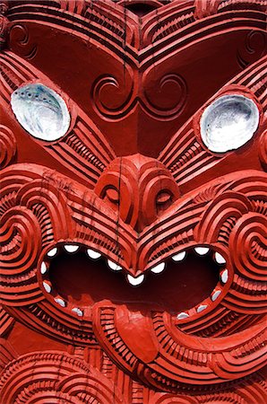 figura - New Zealand,North Island,Rotorua. Carvings on a Whare Whakairo meeting house in Te Puia Maori Village. Carvings in particular were a means of preserving tribal history in an oral society,carved figures represent dead persons and manifestations of an ancestor. Foto de stock - Con derechos protegidos, Código: 862-03360081