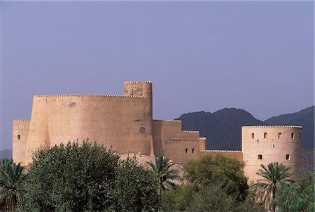 simsearch:862-03437387,k - The first Rustaq Fort was built by the Persians in the pre-Islamic period. It became the capital of the Ya'ruba dynasty and was subsequently re-built in the 17th Century. Oman's second largest fort,it sits at the foot of Jabal al Akhdar on the edge of the Batinah Plain. Stock Photo - Rights-Managed, Code: 862-03360172