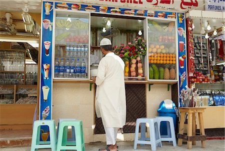 dhofar - Oman,Dhofar. A passerby stops for refreshment at one of the juice bars in Salalah. Stock Photo - Rights-Managed, Code: 862-03360344
