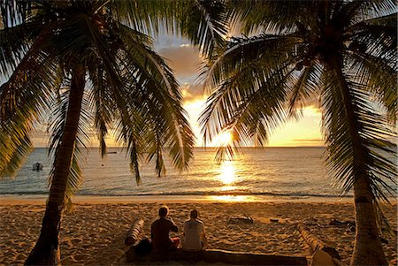 romantic beach sunset - South Pacific,Fiji,Kadavu. Conservation volunteers watching the sunset. Stock Photo - Rights-Managed, Code: 862-03360376