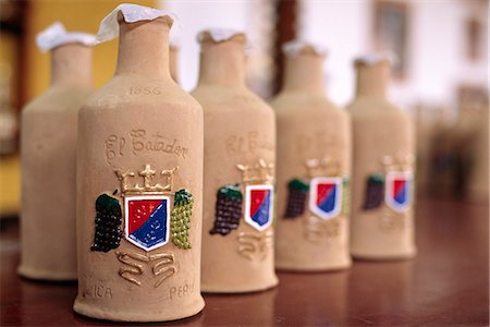 Decorative bottles of Pisco Sour at a bodega (vineyard) on the outskirts of Ica,in southern Peru. Pisco Sour,a white-grape brandy,is the Peruvian national drink. Stock Photo - Rights-Managed, Code: 862-03360530