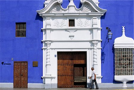 Ein Mann übergibt die komplizierten Schmiedearbeiten und Pastelltönen eines kolonialen Herrenhauses auf der Plaza de Armas in Trujillo, Peru Stockbilder - Lizenzpflichtiges, Bildnummer: 862-03360581