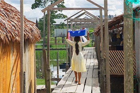 south american indian - Peru,Amazon River. Indigenous Indian girl carrying her washing in the village of Islandia. Stock Photo - Rights-Managed, Code: 862-03360632