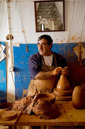 Portugal,Alentejo,Estremoz. A Portuguese potter at work in his studio in the Alentejo region of Portugal which is famous for its ceramics. Stock Photo - Rights-Managed, Code: 862-03360937