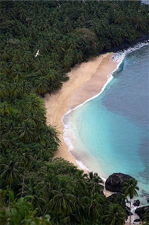 santomean - Praia da Banana (banana beach) on the island of Principé. Sao Tomé and Principé is Africa's second smallest country with a population of 193 000. It consists of two mountainous islands in the Gulf of New Guinea,straddling the equator,west of Gabon. Principé is the smaller of the two islands with a population of around 5000. Stock Photo - Rights-Managed, Code: 862-03361296