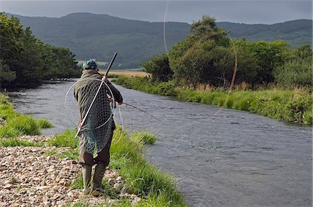 simsearch:862-03361511,k - A salmon fisherman fly fishing the Drumlaing Glide on the southern bank of the River Ba on the Benmore Estate Beat. Stock Photo - Rights-Managed, Code: 862-03361545