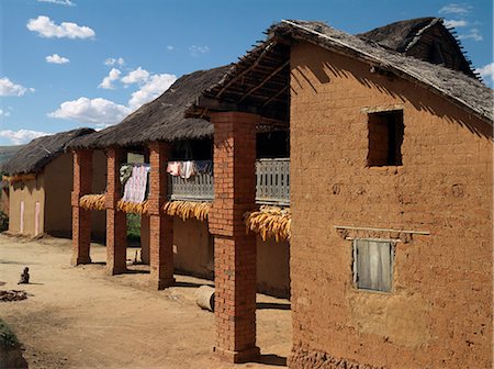 Maize cobs hanging to dry from the balconies of houses in a typical Betsileo village,Madagascar. Stock Photo - Rights-Managed, Code: 862-03363988