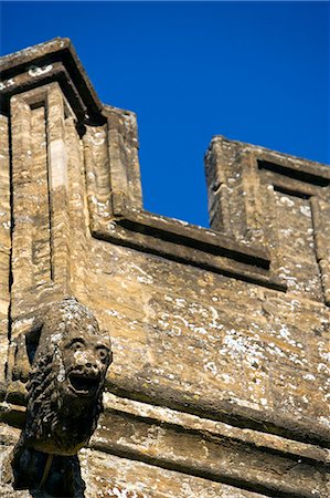 England,Somerset,Crewkerne. St Bartholomew's Parish Church stands on higher ground west of the town centre. It is the focal point of the rural prospect of the western side of the town - a superb example of the Perpendicular style with many unusual and individual features. Highlighted here are its highly individual gargolyes or more correctly its chimera. Stock Photo - Rights-Managed, Code: 862-03437061