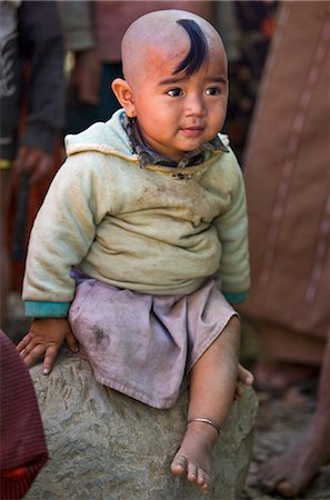 Myanmar,Burma,Rakhine State,Gyi Dawma. A young girl at Gyi Dawma village. The small tuft of hair on her shaven head is believed to protect her. Stock Photo - Rights-Managed, Code: 862-03437279