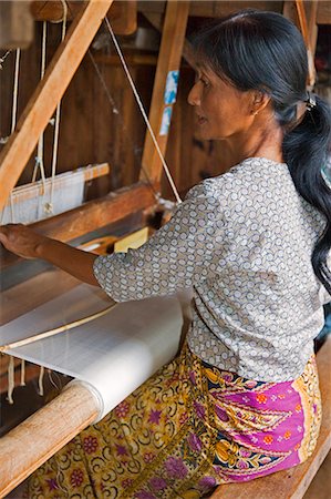 Myanmar,Burma,Lake Inle. A woman weaves lotus fibres to produce very fine cloth,more expensive than silk. Lotus weaving has existed at Lake Inle for 90 years and nowhere else. Stock Photo - Rights-Managed, Code: 862-03437272