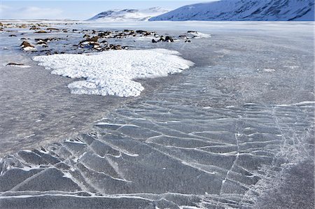simsearch:862-03365677,k - Norway,Troms,Lyngen Alps. High on the plateau,the pressure of freezing and the weather conditions,create dramatic patterns on the flat surfaces of the area's lakes. Stock Photo - Rights-Managed, Code: 862-03437288
