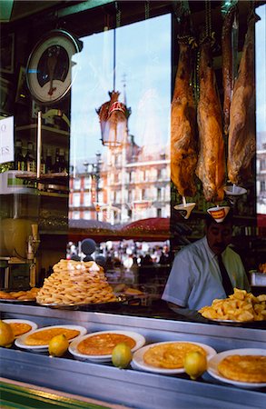 Hams hang above a food counter in the window of a restaurant in the Plaza Major Stock Photo - Rights-Managed, Code: 862-03437363