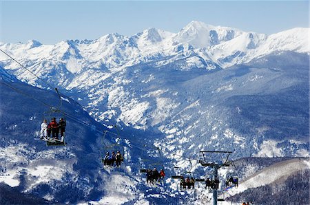 skiers and chairs lifts in snow - USA,Colorado,Vail Ski Resort. Skiers being carried on a chair lift in Vail back bowls Stock Photo - Rights-Managed, Code: 862-03437564