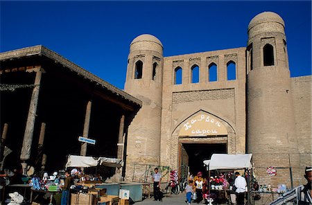 Uzbek families wander round the street market in front of The West Gate to the Ichan Kala,the old city of Khiva. Stock Photo - Rights-Managed, Code: 862-03437666