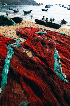 Fishing nets laid out on the beach after the day's work Stock Photo - Rights-Managed, Code: 862-03437681