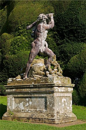 Wales; Powys; Welshpool. Statue of Hercules killing the Hydra against the backdrop of a massive yew hedge in the spectacular garden at Powis Castle Foto de stock - Direito Controlado, Número: 862-03437854