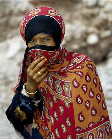 A woman at Arerhen Quaryah,a coastal fishing village,has smeared saffron on her skin to lighten it. The island's proximity to the ancient direct sea routes from the Red Sea to India and to East Africa is reflected in the diverse origins of its 45,000-50,000 population. Many Socotrans living along the coast are of mixed Arab and African descent. Stock Photo - Rights-Managed, Code: 862-03437903