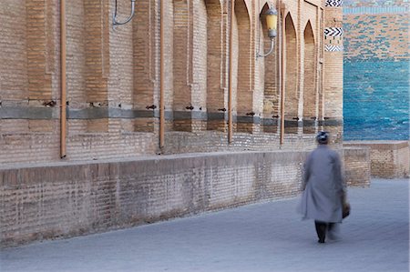 Muslim man walking along street, Khiva, Uzbekistan Stock Photo - Rights-Managed, Code: 862-03714192