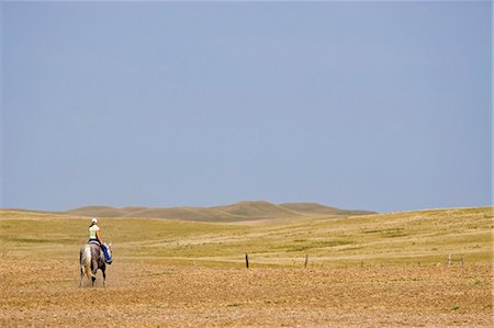 prairies canada - Canada. A woman rides a horse on the Canadian Prairie Stock Photo - Rights-Managed, Code: 862-03710624