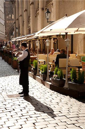 street with cafe - Czech Republic, Prague. A waiter tries to drum up business outside a restaurant in Prague. Stock Photo - Rights-Managed, Code: 862-03710822