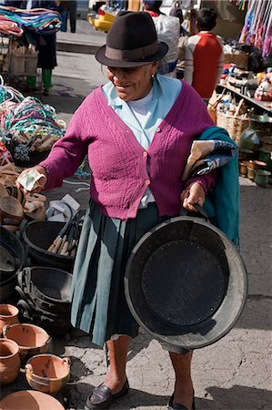 Ecuador, An old woman buys a bucket for feeding pigs made from old rubber tyres at Sangolqui market. Stock Photo - Rights-Managed, Code: 862-03710887