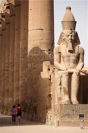 egypt tourists - Egypt, Luxor. A pair of tourists wander down the avenue of massive columns at Luxor Temple. Stock Photo - Rights-Managed, Code: 862-03710919