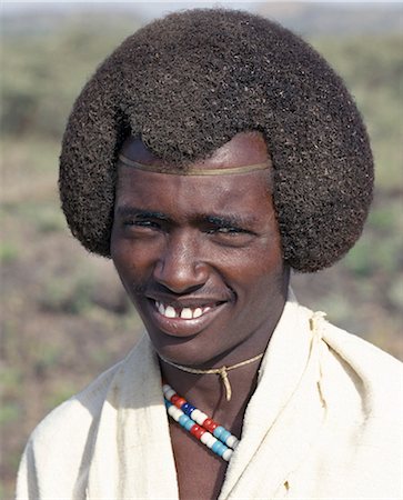 A Kereyu man with his fuzzy,well-oiled hair fashioned in a semi-circular shape. He wears unbleached cloth made from local cotton. Stock Photo - Rights-Managed, Code: 862-03711119