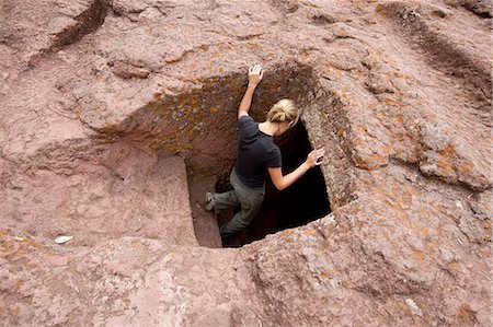 Ethiopie, Lalibela. Un touriste explore un des anciens passages taillés dans le roc de Lalibela. Photographie de stock - Rights-Managed, Code: 862-03711134