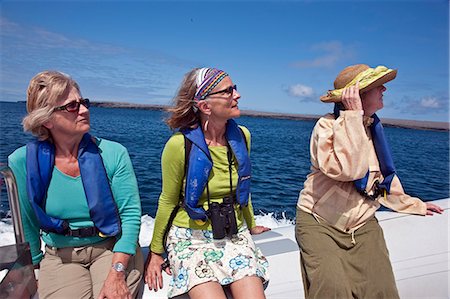 Galapagos Islands, Visitors to Genovese Island return to their motor yacht on a  panga  or inflatable rubber dingy. Stock Photo - Rights-Managed, Code: 862-03711572