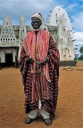 Ghana,Northern Region,Larabanga. The Imam stands outside the thirteenth century mosque at Larabanga,near Mole National park. Stock Photo - Rights-Managed, Code: 862-03711638