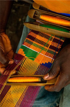 Ghana,Volta region,Tafi Abuipe. Fine Kente cloth being woven. The Ashantis and Ewes both lay claim to having invented it. Stock Photo - Rights-Managed, Code: 862-03711644