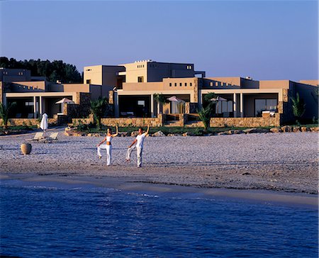 simsearch:862-03711674,k - Yoga on beach in front of the Asterias Suites Fotografie stock - Rights-Managed, Codice: 862-03711654
