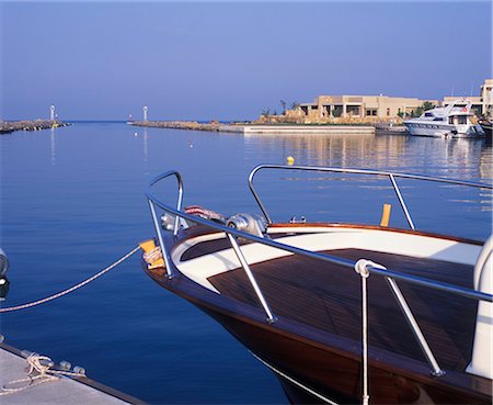 simsearch:862-03711658,k - Boat in the marina with the Asterias Suites in the background Stock Photo - Rights-Managed, Code: 862-03711656