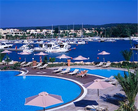 simsearch:862-03711658,k - The marina with the Asterias Suites' swimming pool in the forground Stock Photo - Rights-Managed, Code: 862-03711660