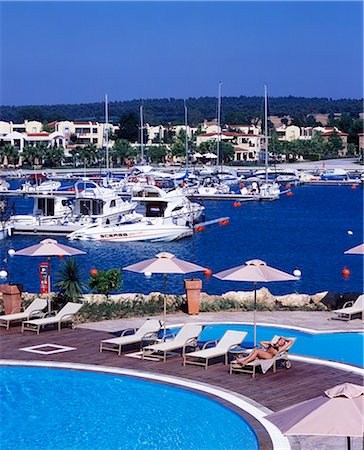 simsearch:862-03711658,k - The marina with the Asterias Suites' swimming pool in the foreround Stock Photo - Rights-Managed, Code: 862-03711661