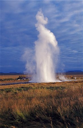 Steam explodes from the ground in a powerful column as Geysir,Iceland's most famous geyser,erupts. Stock Photo - Rights-Managed, Code: 862-03711772