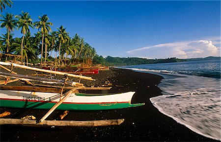 sulawesi - Indonesia,Sulawesi,Tangkoko. Outriggers on a Black sand beach at Tangkoko. Stock Photo - Rights-Managed, Code: 862-03711833