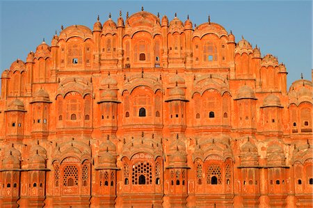 Palace of the Wind at sunrise,Hawa Mahal was built in 1799 is an example of Rajput artistry with its pink delicately honeycombed sandstone windows of which there are 953 Stock Photo - Rights-Managed, Code: 862-03711925