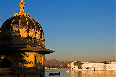 The Lake Palace Hotel appears to rise out of the waters of Lake Pichola. It is one of the most glamorous and romantic hotels in the world.City Palace,Udaipur,Rajasthan. India Stock Photo - Rights-Managed, Code: 862-03711974