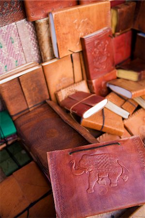 India,Rajasthan,Jaisalmer. In Jaiselmer Fort market,beautifully worked leather book covers for sale in various sizes and decorative styles. Stock Photo - Rights-Managed, Code: 862-03712007