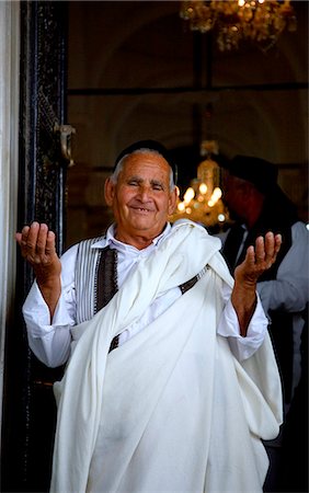 photos of old arab men - Libya, Tripolitania, Tripoli; Posing with hands raised in praise of allah in the door of a Mosque. Stock Photo - Rights-Managed, Code: 862-03712767