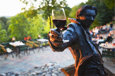 simsearch:862-03712820,k - Lithuania, Vilnius, Uzupis District, Statue Holding Glass Of Red Wine At Outdoor Patio At Tores Restaurant Stock Photo - Rights-Managed, Code: 862-03712822