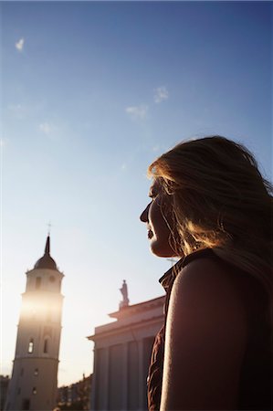 Lithuania, Vilnius, Woman Sitting In Cathedral Square With Vilnius Cathedral Belfry In Backgroun. Stock Photo - Rights-Managed, Code: 862-03712845