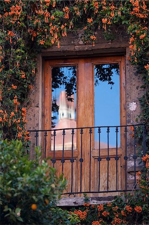 simsearch:862-03712887,k - San Miguel de Allende; Mexico; An attractive spanish style balcony with the refelction of a church spire Stock Photo - Rights-Managed, Code: 862-03712889