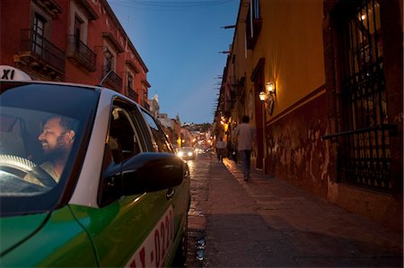 simsearch:862-03712882,k - A taxi driver in San Miguel de Allende Mexico sits in his car waiting for a fare Foto de stock - Con derechos protegidos, Código: 862-03712897